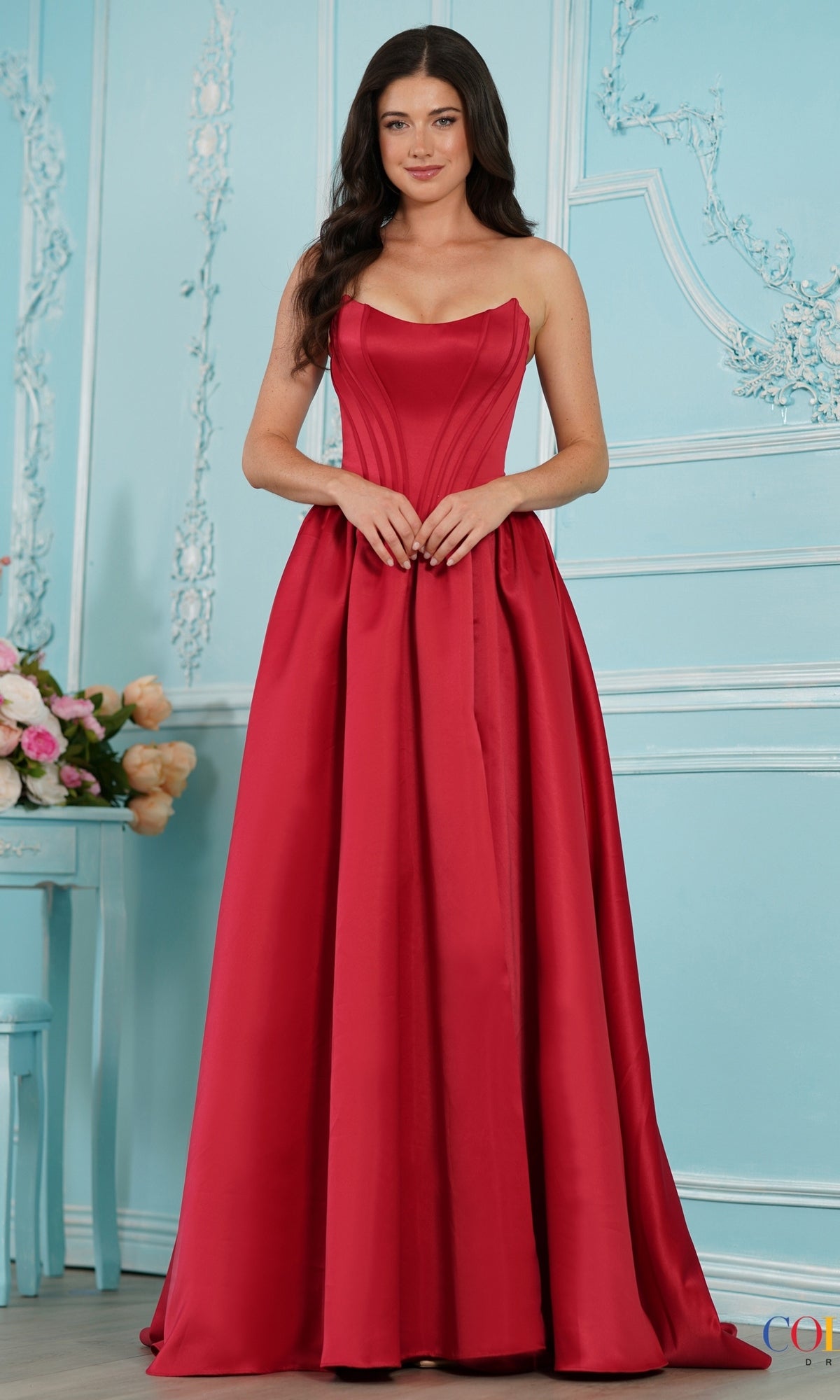 A floor-length red Long Prom Dress: Colors Dress 3997 with a structured, strapless bodice and a full, pleated skirt.